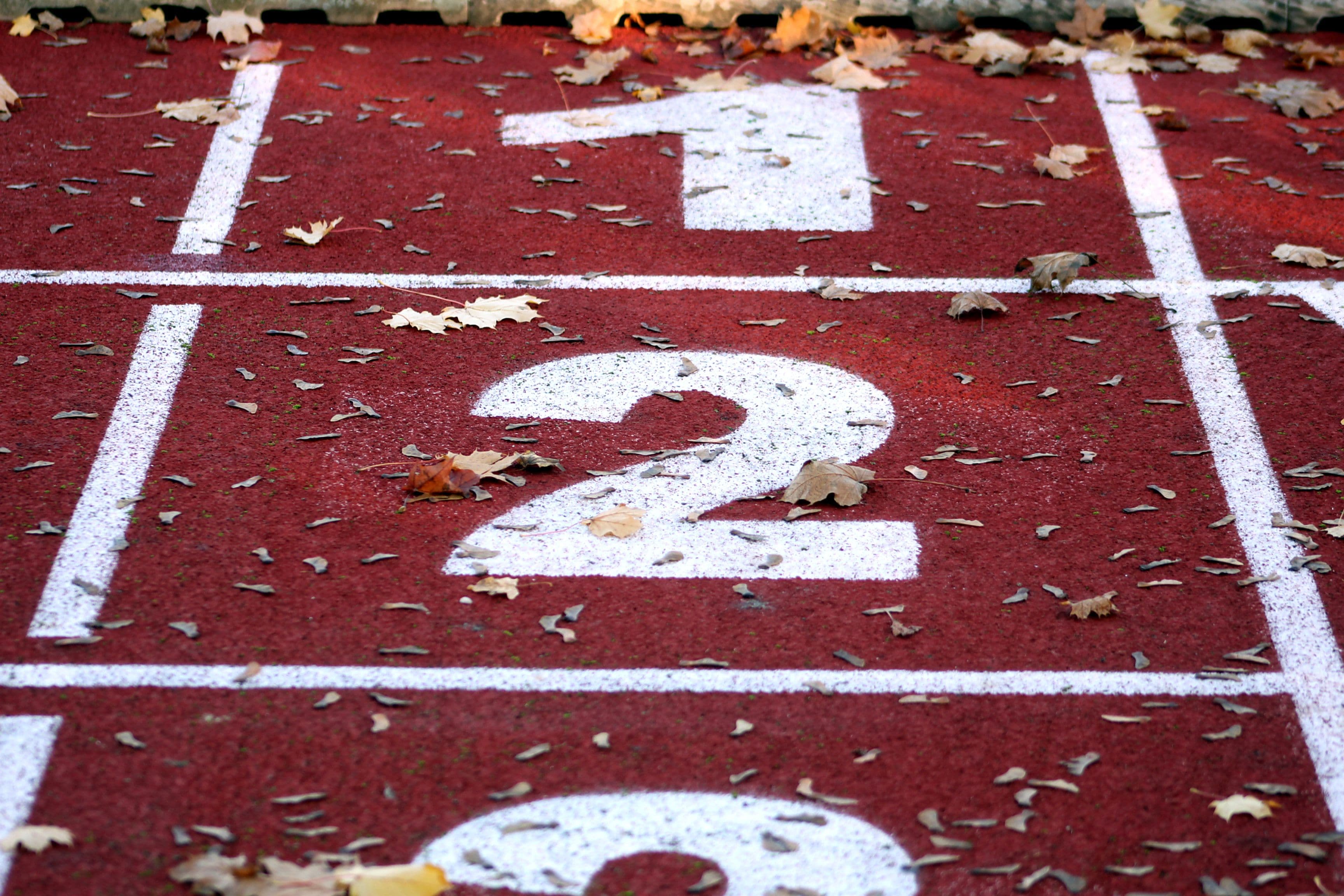 the numbers 1 and 2 are painted on a red track .