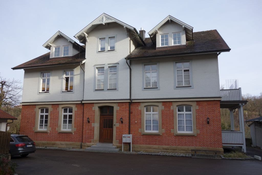 a large brick building with a car parked in front of it .